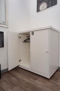 a room with two white cabinets next to a wall at PH Palermo Hostel in Buenos Aires