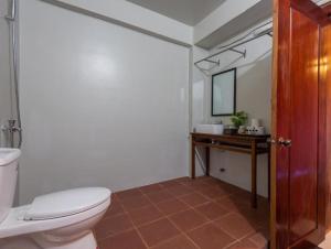 a bathroom with a toilet and a sink and a mirror at Sihariddh Angkor Villa in Siem Reap