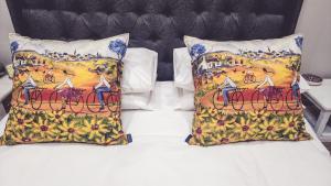 a bed with two pillows on top of it at Peper Korrel in Paarl