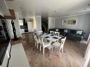 a living room with a table and chairs and a couch at Merkel Villa Apartamente in Wiesbaden