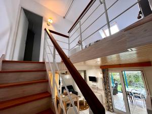 a house with a staircase and a living room at Keraven, charmante maisonnette, piscine commune 1-4 personnes in Moëlan-sur-Mer