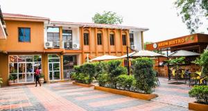 a person walking in front of a building at Aron International Hotel in Juba