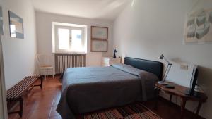 a bedroom with a bed and a table and a window at Al Ponte di Tiberio in Rimini