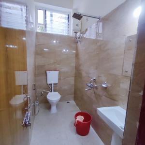 a bathroom with a toilet and a sink and a shower at A K CONTINENTAL in Rānchī