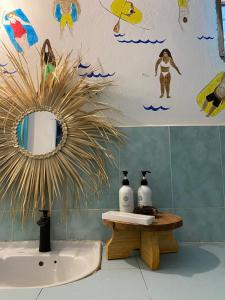 a bathroom with a sink and a mirror on the wall at FURAHA BEACH ROOMS in Kendwa
