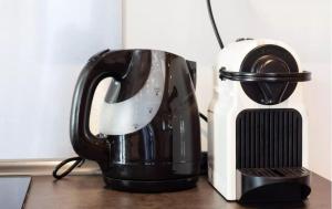 a black coffee maker sitting next to a toaster at Studio hypercentre Marseille in Marseille