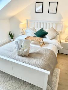 a bedroom with a white bed with a table on it at Luxury en-suite double bedroom Stratford E15 in London