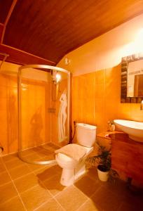a bathroom with a toilet and a shower and a sink at Havana Nights Phi Phi in Phi Phi Don