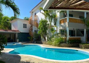 a swimming pool in front of a building at Bahia Residence Cabarete in Cabarete