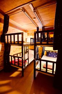 a room with three bunk beds and a table at Havana Nights Phi Phi in Phi Phi Islands