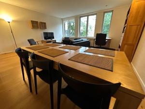 a conference room with a large wooden table and chairs at 2 Bedroom Apartment in Lovely Louise Area in Brussels