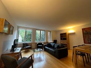 a living room with a couch and a table at 2 Bedroom Apartment in Lovely Louise Area in Brussels