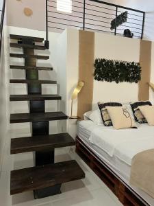 a bedroom with a staircase next to a bed at Pousada Reloday in Salvaterra