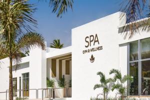a white building with a spa sign on it at Riu Palace Macao - Adults Only - All Inclusive Elite Club in Punta Cana
