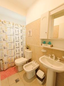 a bathroom with a white toilet and a sink at TIDES Apart de playa in Ostende +93 photos