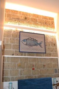 a picture of a fish on a brick wall at B&B Charming House in Salerno