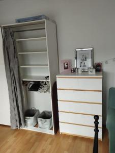 a room with a dresser and a closet with a drawer at Kasia apartament in Poznań
