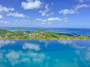 a view of the ocean from a swimming pool at Villa Grand Horizon with extraordinary 180 degree sea view in Saint Martin
