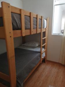a couple of bunk beds in a room at Apartamentos Cristo Rey. in Tacna
