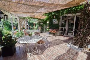 a patio with a table and chairs on a patio at B&B Olbia in Olbia