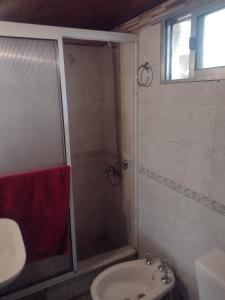 a bathroom with a shower and a sink at Casa Los Acantilados in Mar del Plata