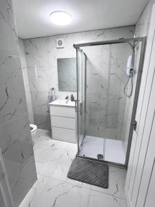 a bathroom with a shower with a toilet and a sink at Harmony home Lindley Huddersfield in Lindley