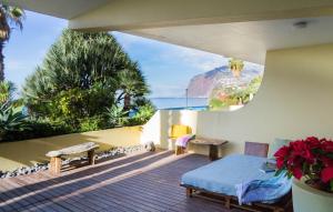 a balcony with a bed and a view of the ocean at By the Atlantic Apartments 3-bedroom in Funchal