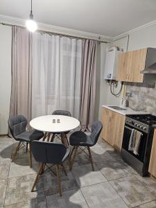 a kitchen with a table and chairs in a room at Premium apartment 1 in Lviv