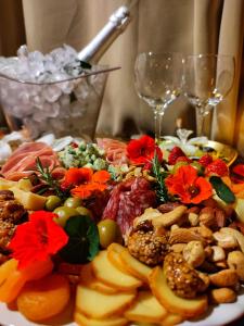 a plate of food on a table with wine glasses at Prana Guest House in Praia do Rosa