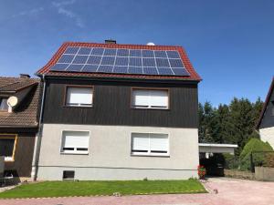 a house with solar panels on the roof at Harzquerbahnblick in Benneckenstein