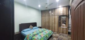 a bedroom with a bed and a wooden wall at vista guest house in Quetta