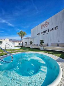 a large blue hot tub in front of a building at MB Boutique Hotel - Adults Recommended in Nerja