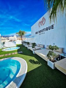 a building with a swimming pool in front of it at MB Boutique Hotel - Adults Recommended in Nerja