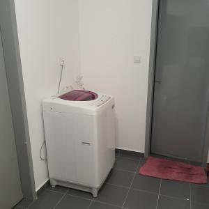 a white washer and dryer in a bathroom with a shower at D Laman Haris Homestay in Bandar Puncak Alam +5 photos