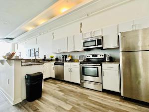 a kitchen with white cabinets and stainless steel appliances at Executive Vacation Suite for 4 in Indianapolis