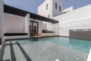 a swimming pool in the middle of a house at Laguna Suites in Mazera Mykonos in Mikonos
