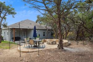 a house with a patio with a table and chairs at Tranquil Oasis near Canyon Lake home in Spring Branch