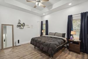 a bedroom with a bed and a ceiling fan at Tranquil Oasis near Canyon Lake home in Spring Branch