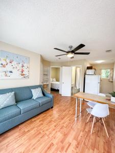 a living room with a couch and a table at Oasis by the Bay Vacation Suites in Wasaga Beach