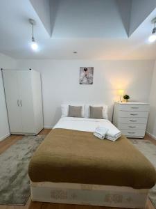 Cosy Stunning Flat في لندن: غرفة نوم بسرير كبير وكابينة بيضاء