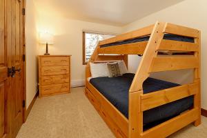 a bedroom with a bunk bed with a ladder at 700 Monarch 205, Deluxe Condo with Private Deck & Mountain Views Located 1 Block to Ski Lift in Aspen