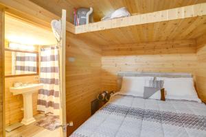 a bedroom with a bunk bed in a wooden room at Peaceful South Bend Vacation Rental with Fire Pit in South Bend