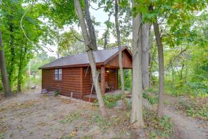 a small wooden cabin in the middle of trees at Peaceful South Bend Vacation Rental with Fire Pit in South Bend