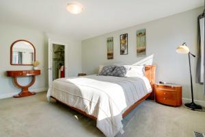 a bedroom with a bed and a table and a mirror at Anchorage Retreat Charming Home with Private Deck! in Anchorage