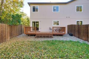 a backyard with two benches in front of a house at Anchorage Retreat Charming Home with Private Deck! in Anchorage