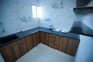 a kitchen with a sink and a counter top at Velvet Vista Premier Service Apartments in Mysore in Mysore