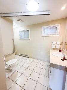 a bathroom with a toilet and a sink at Oasis by the Bay Vacation Suites in Wasaga Beach