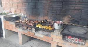 a grill with many different types of food on it at Centro Vacacional Campo Alegre in Guamal