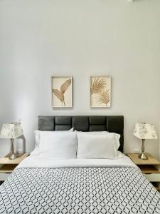 Un pat sau paturi într-o cameră la Cal Bed & Breakfast Ibague