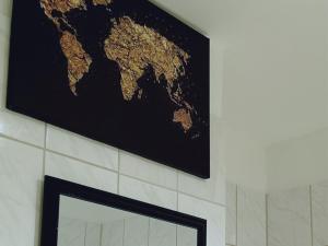 a map of the world hanging on a wall at THE BLACKTAGON Cozy Apartment in Frankfurt